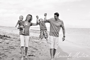 family in black and white at the beach