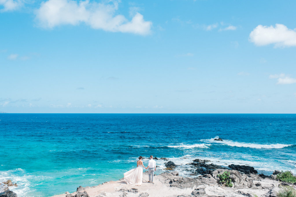 Couple elopes against a blue ocean on Maui - small wedding on cliffs 