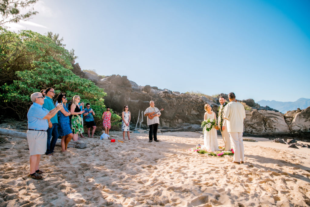 Close friends and family watch as the couple marries on Ironwood Beach in Kapalua Maui
