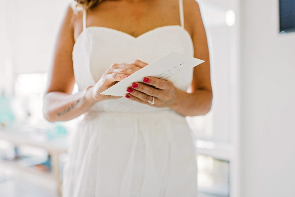 Bride opens love letter from her groom at Kapalua Villas 