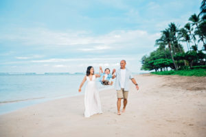 family swinging child on a maui beach