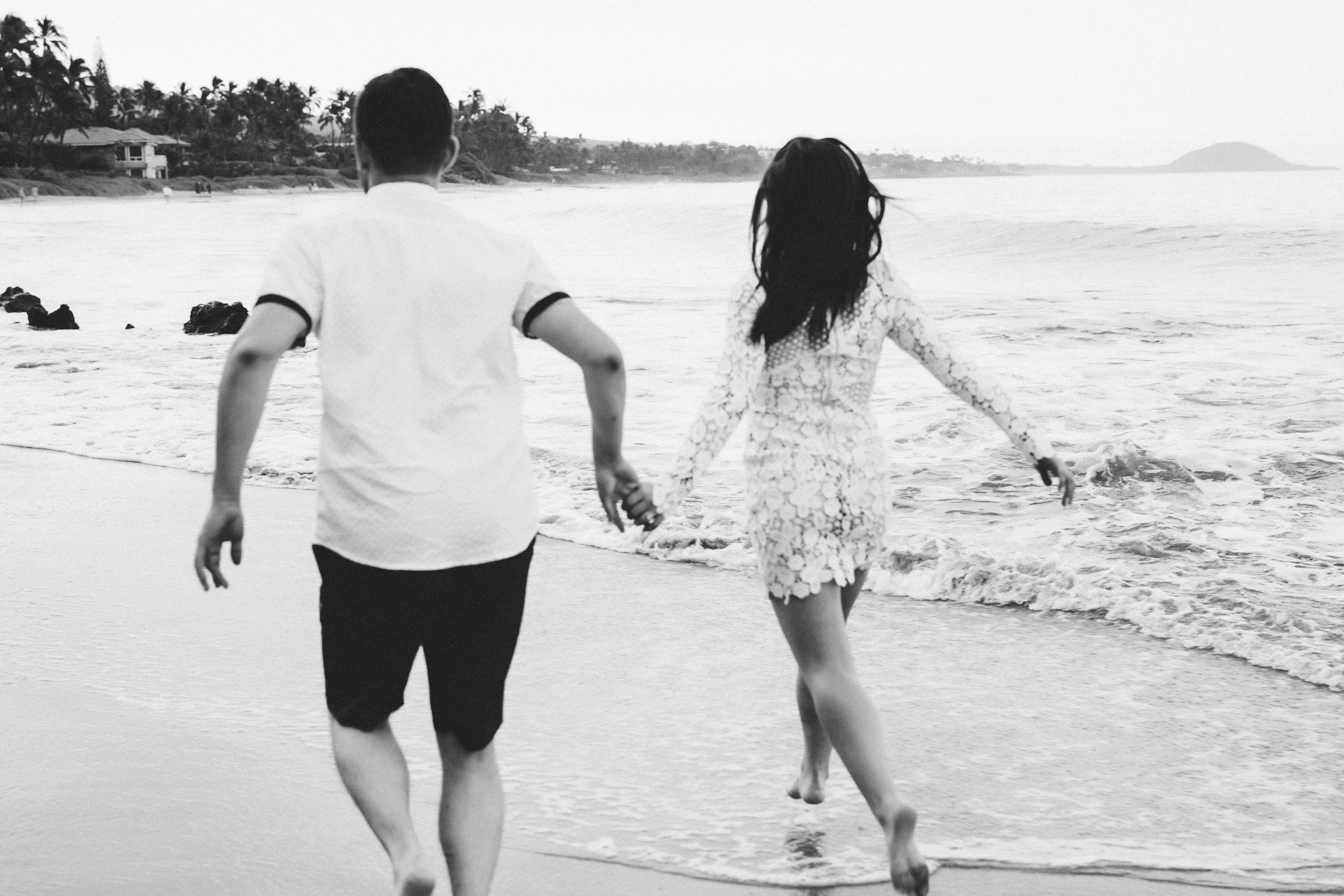 couple running along the beach on Maui