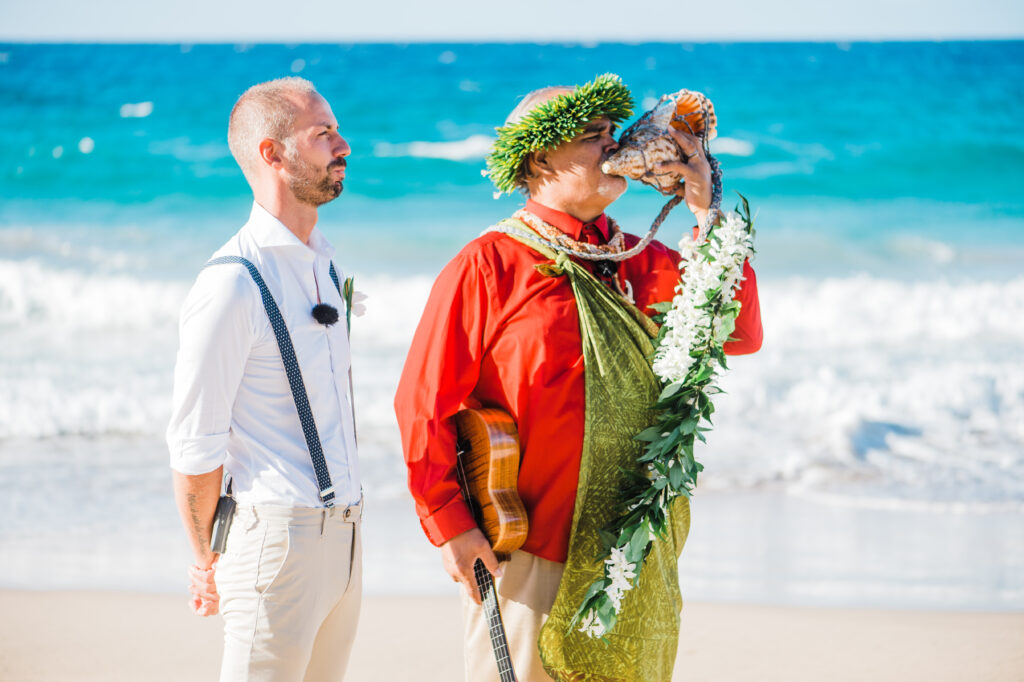 Groom and Officiant looking at the bride walking before their elopement in Maui.