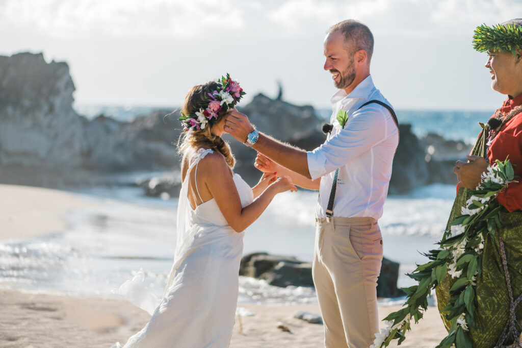 Groom gently wipes the bride’s tears during their elopement, a tender and emotional moment.