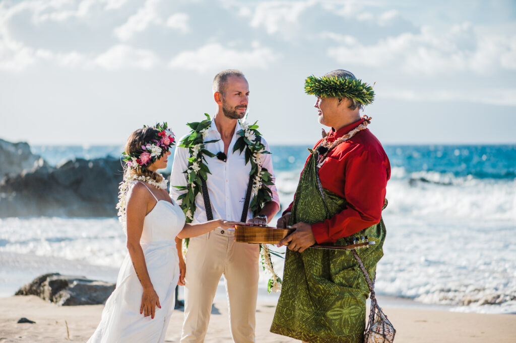 Bride and groom look at the officiant as they exchange vows during their intimate elopement ceremony.