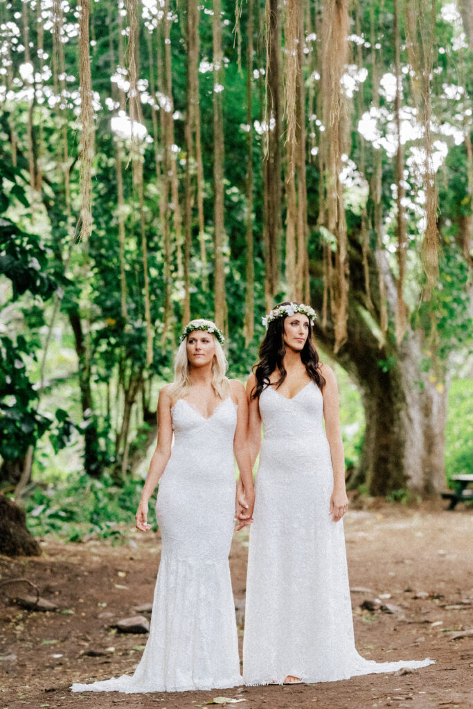 The newlyweds stand hand in hand, celebrating their love in nature’s paradise.