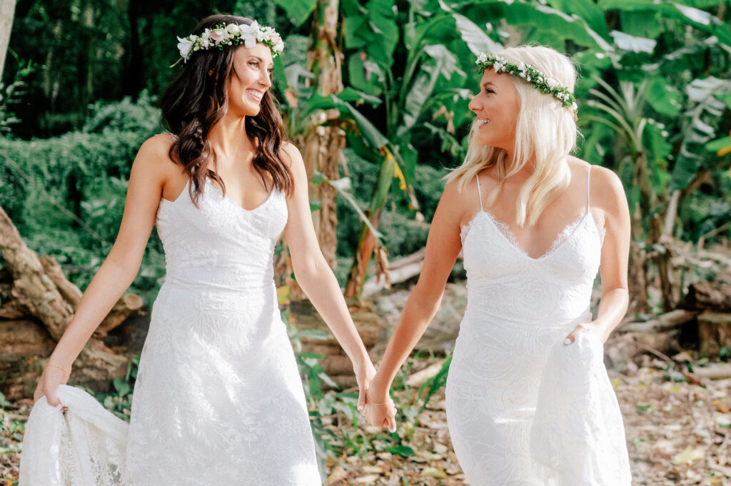 Hand in hand, Dori & Natalie walk through Honolua Forest, radiating joy after their ceremony.