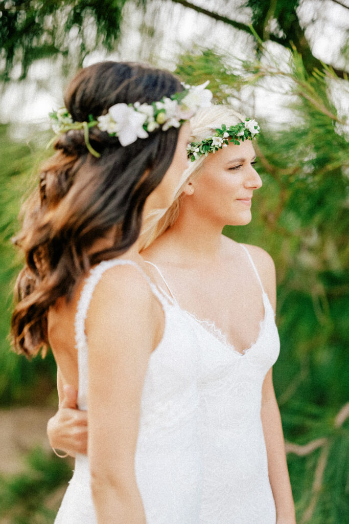 A gentle embrace between the brides, symbolizing love and connection on their wedding day.