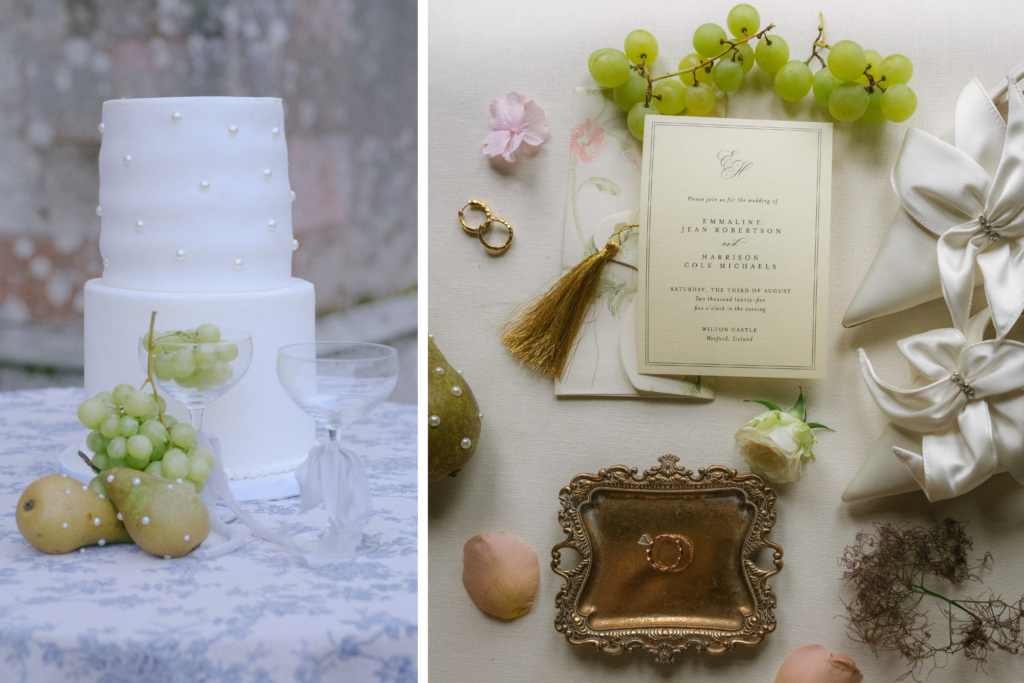Minimalist white wedding cake on a marble table with fresh grapes and glass decor for elegance.