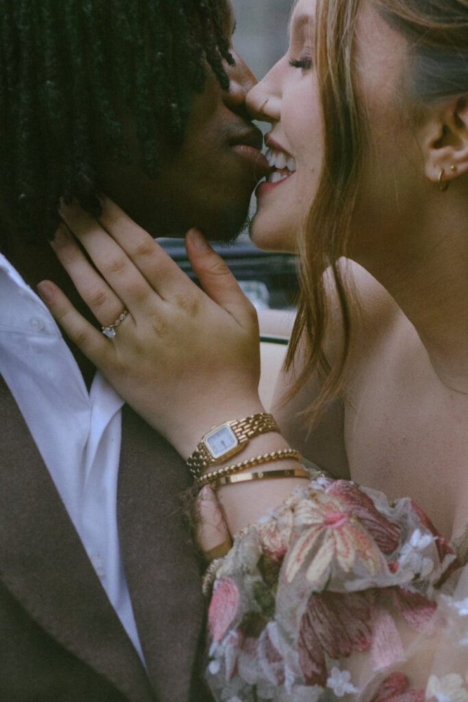 Bride and groom share an intimate moment, smiling and embracing with love in their eyes.