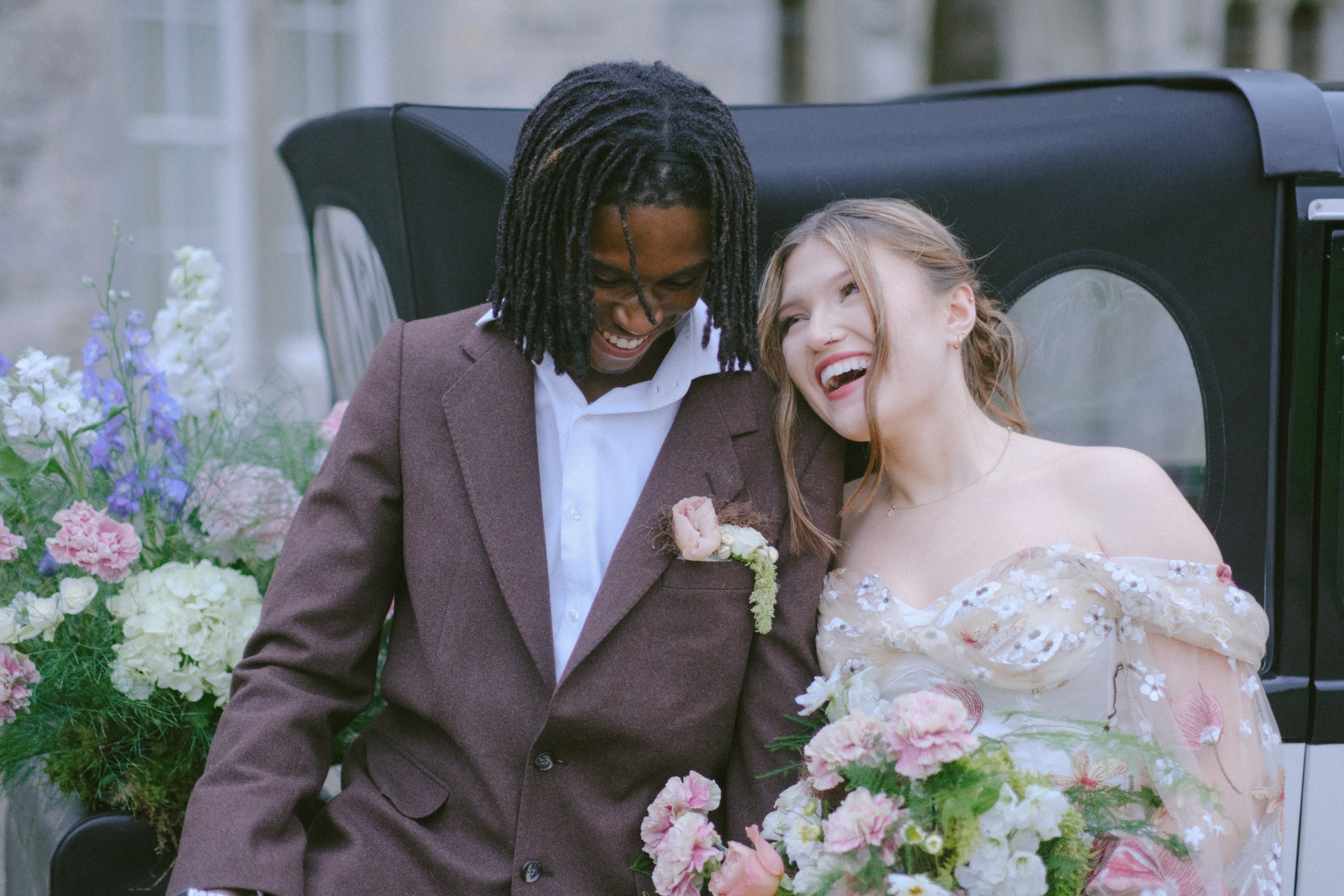 Bride and groom laugh together, exuding love and happiness amid vibrant wedding decor in Ireland.